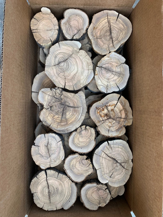 box containing olive log slices with crazy grain patterns